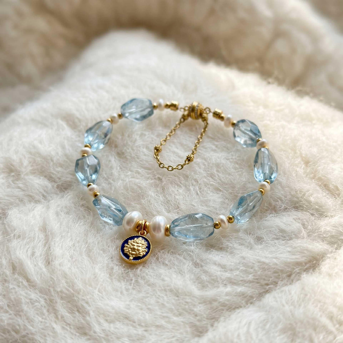 Kubera Azure Topaz Himalayan Bracelet with faceted topaz beads, freshwater pearls, and a lapis lazuli Kubera charm